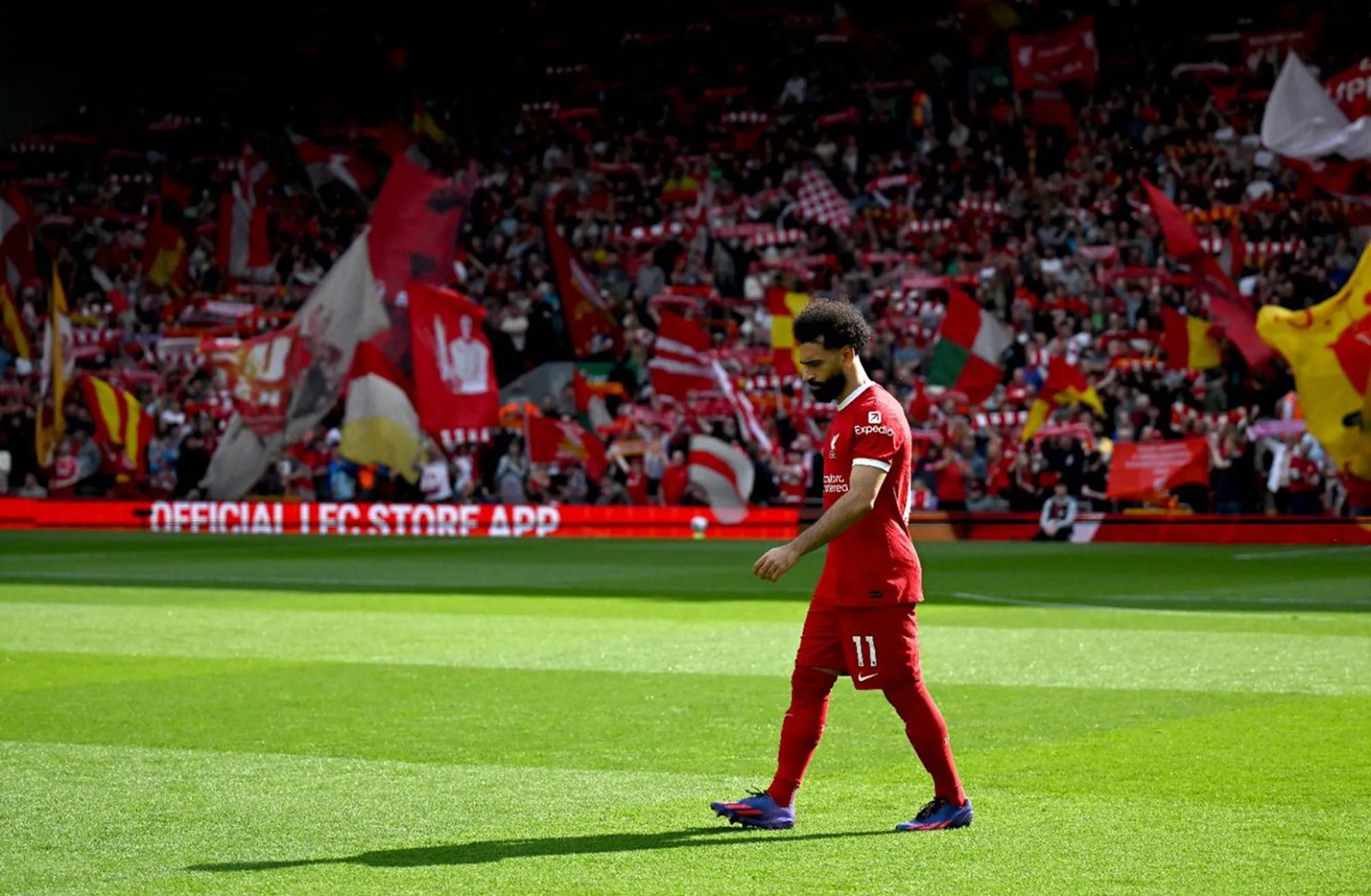 A dejected Mohamed Salah walking on the field at Anfield after the season's final match.