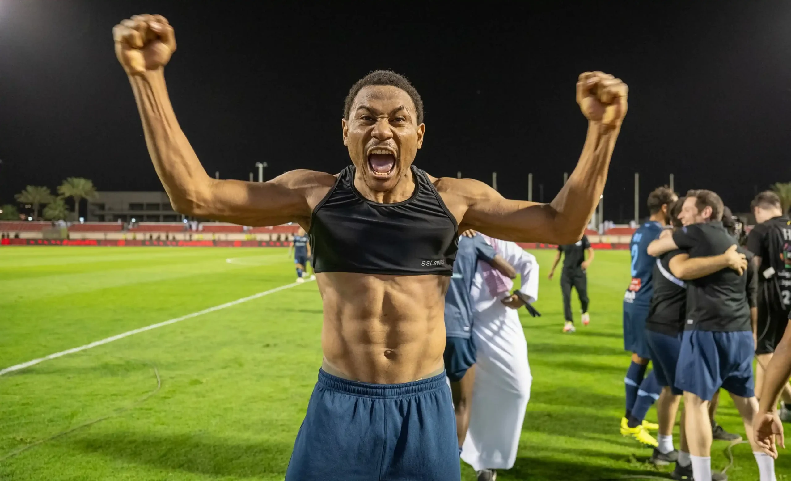 Goal scorer Léandre Tawamba celebrates Al Okhdood's survival.