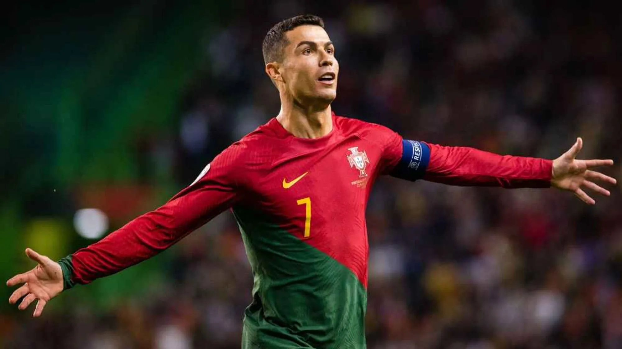 Cristiano Ronaldo in Portugal's jersey, with arms outstretched during a match.