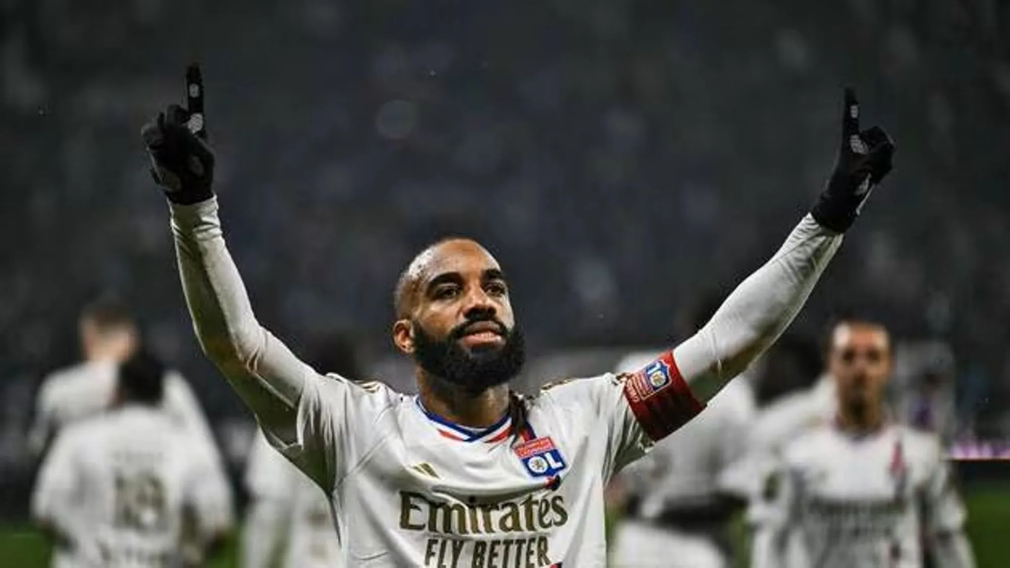 Alexandre Lacazette Lifts His Hands in Celebration After a Goal in a Past Match.