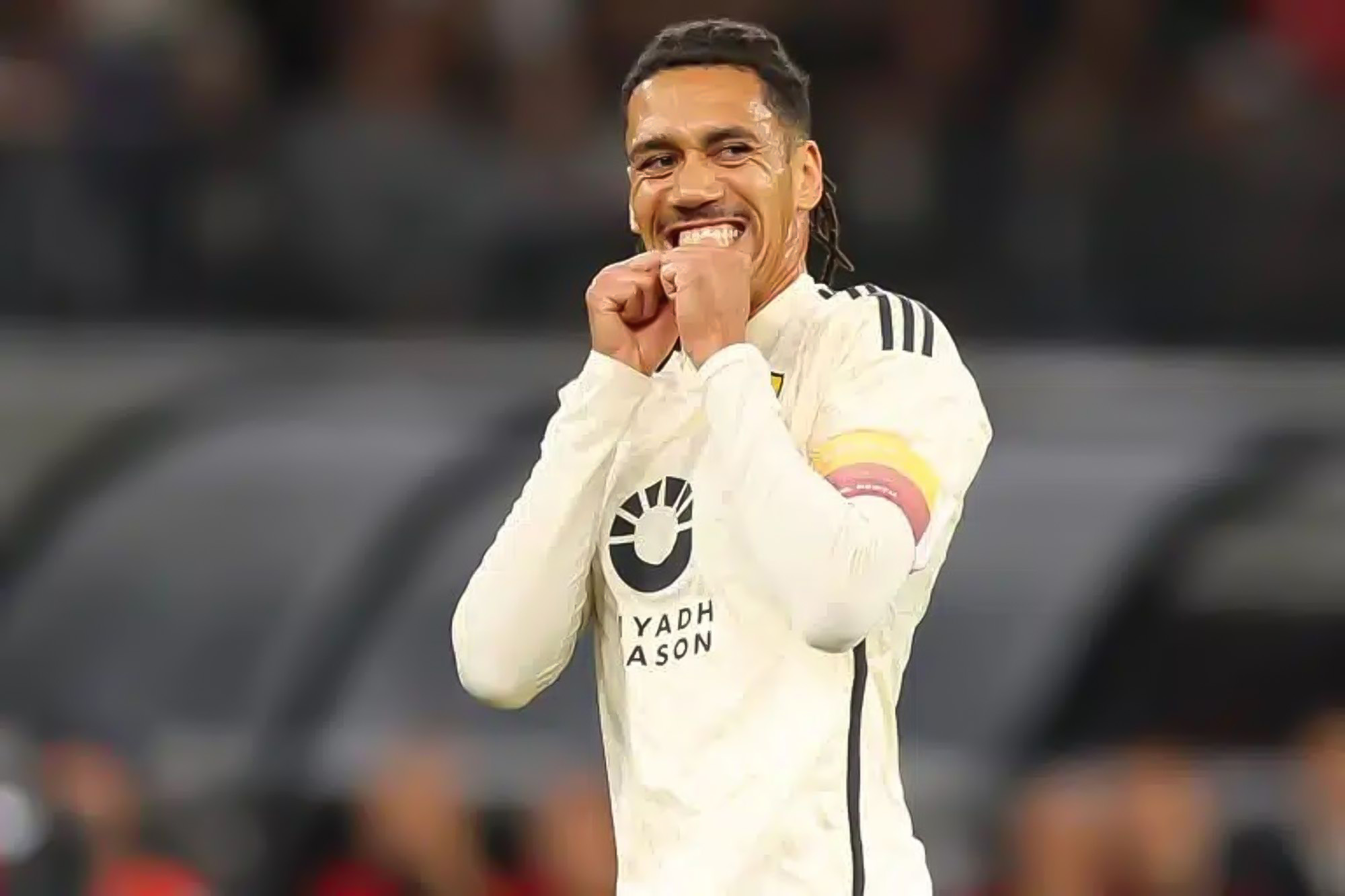 Chris Smalling, in an AS Roma away jersey, clasping his hands near his face during a past match.