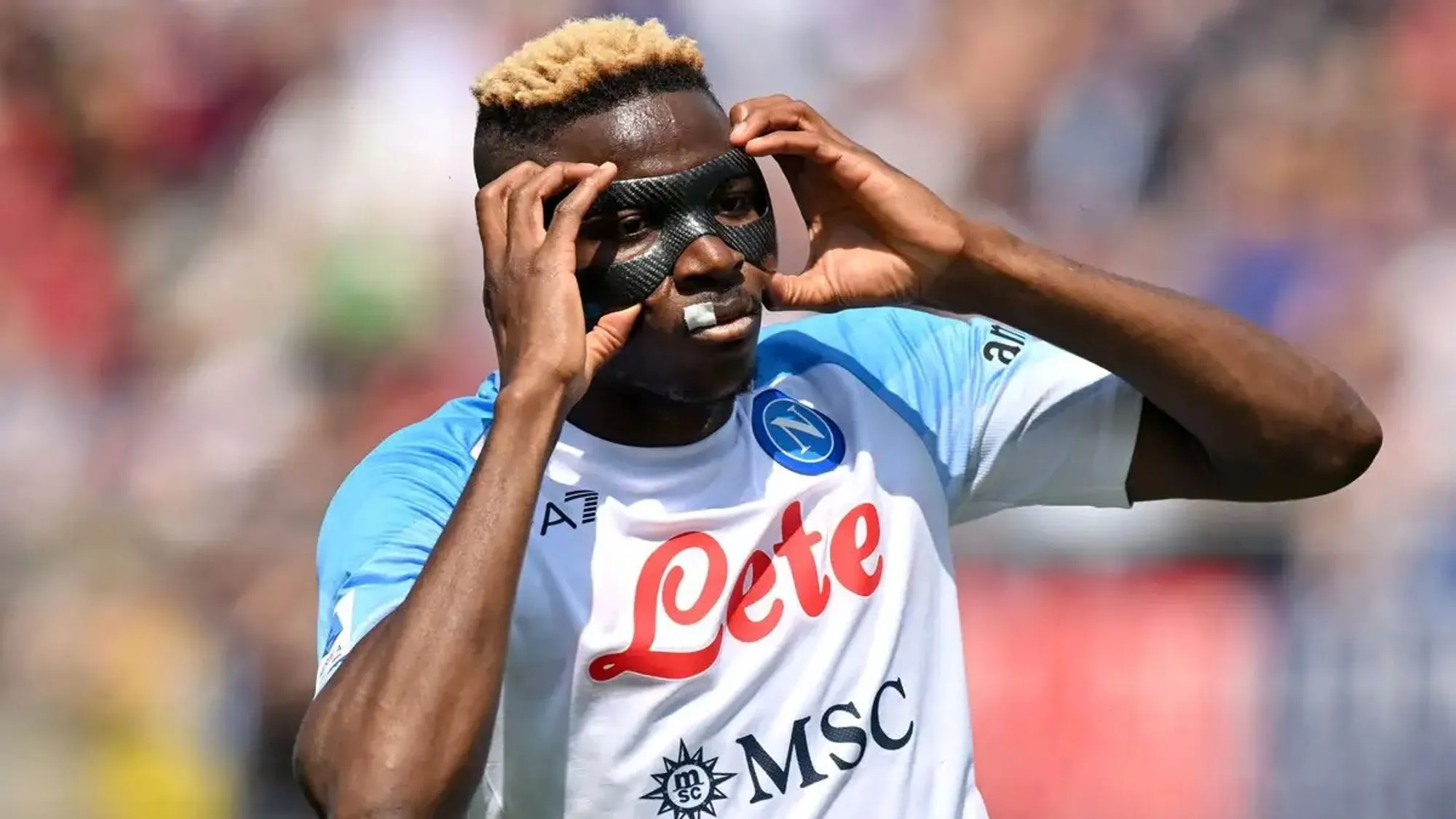 Victor Osimhen Holds Onto His Protective Mask As He Celebrates A Goal in a Past Match