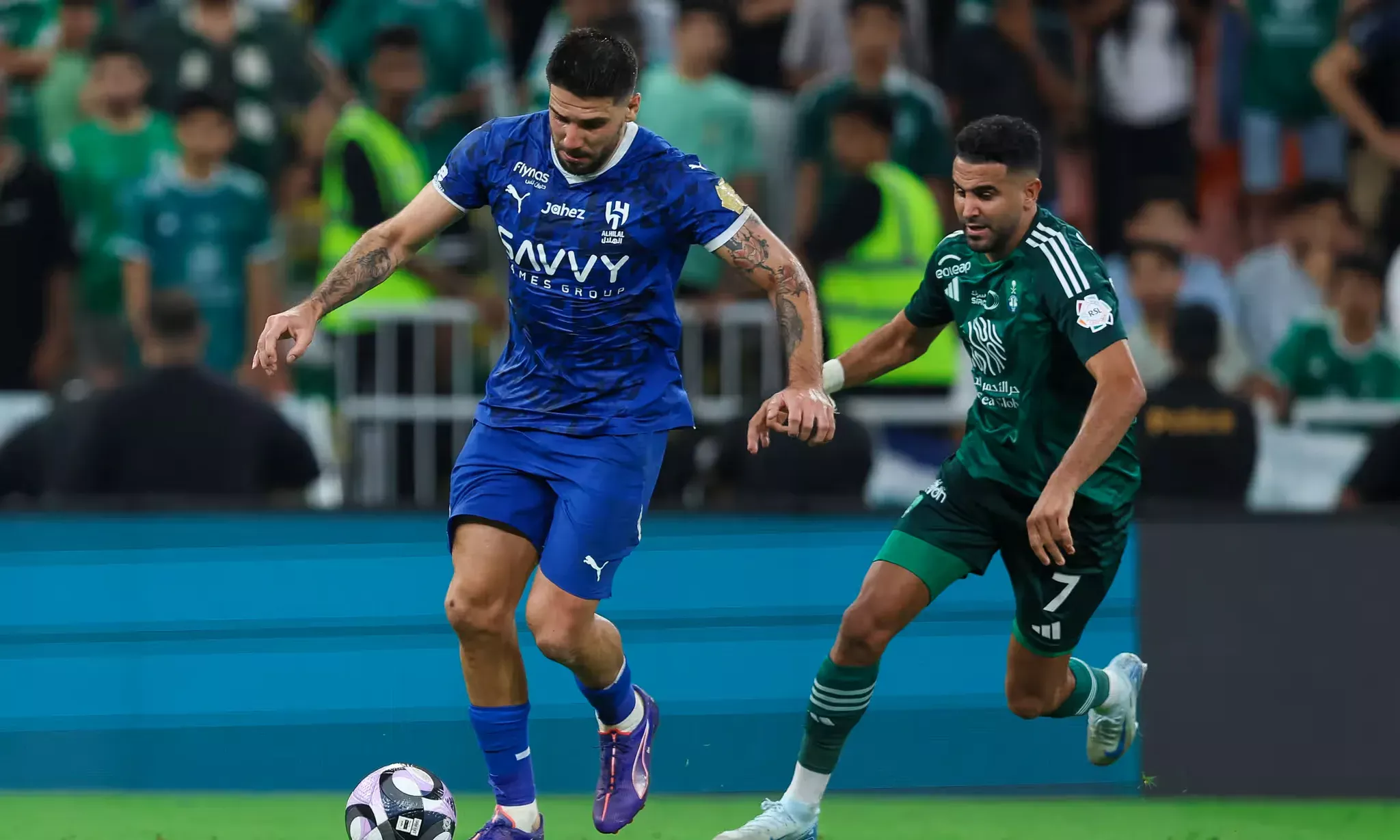 Riyad Mahrez and Aleksandar Mitrovic tussle for the ball during the Al Ahli-Al Hilal SPL match, which Al Hilal won.