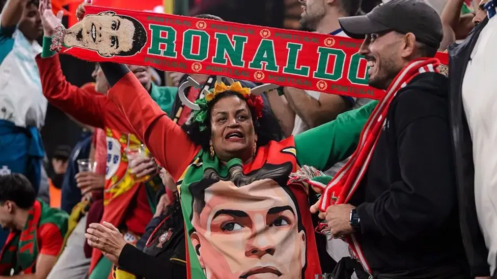 A Portugal supporter holds a Cristiano Ronaldo scarf in the stands after he seemingly quit the Portuguese national team